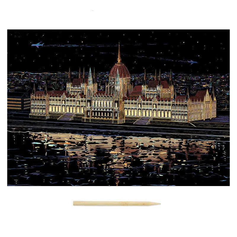Framed artwork of a illuminated building at night with a white border