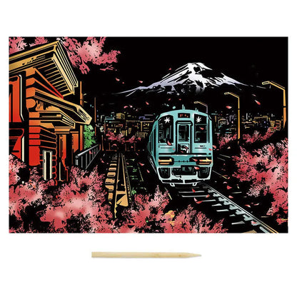 Train on tracks with cherry blossoms and a mountain in the background